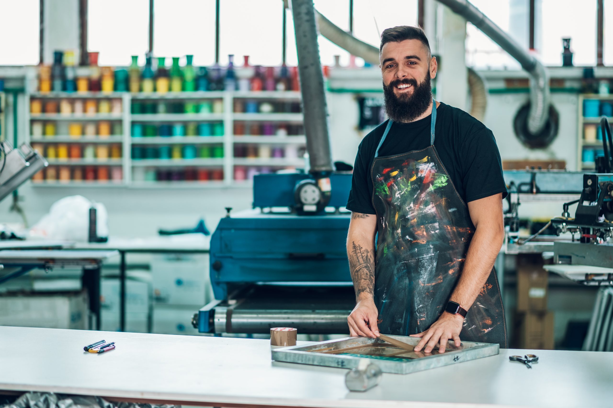 male-worker-preparing-screen-printing-film-in-a-wo-2023-11-27-05-17-15-utc