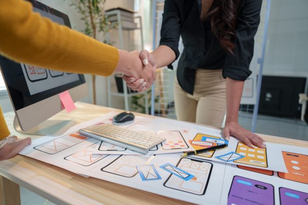 two-ux-designers-shaking-hands-after-successfully-2025-02-20-03-55-59-utc