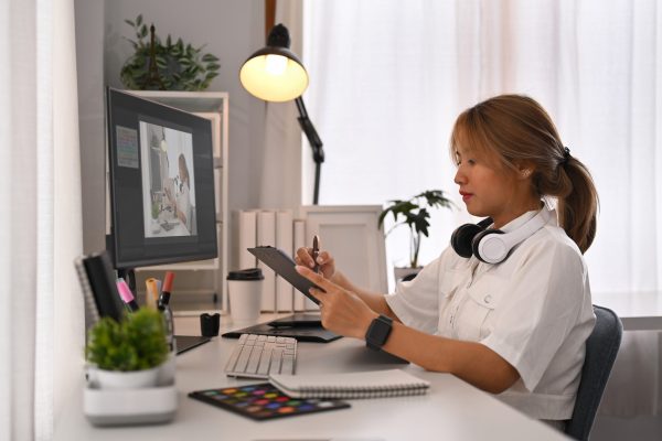 creative-woman-using-digital-tablet-working-on-de-2024-11-28-12-12-19-utc