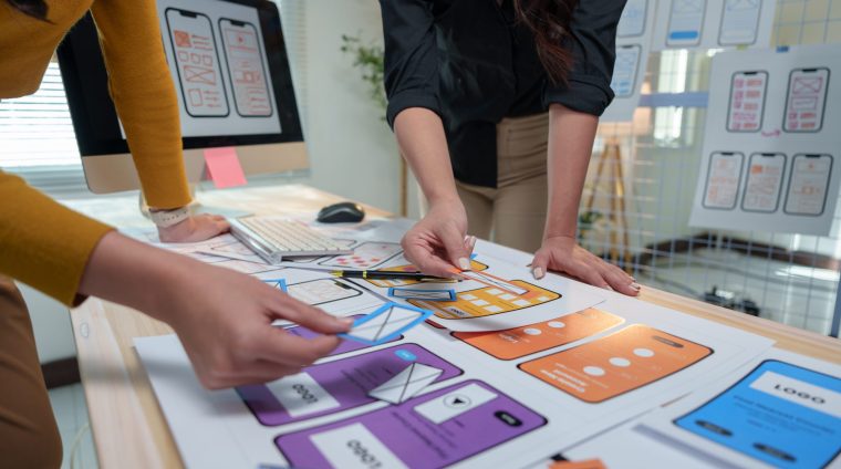 two-female-ux-designers-are-collaborating-on-a-pro-2025-02-20-03-55-55-utc two-female-ux-designers-are-collaborating-on-a-pro-2025-02-20-03-55-55-utc